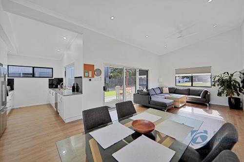 a living room with a table and a couch at 7 Pine Court in Woodgate