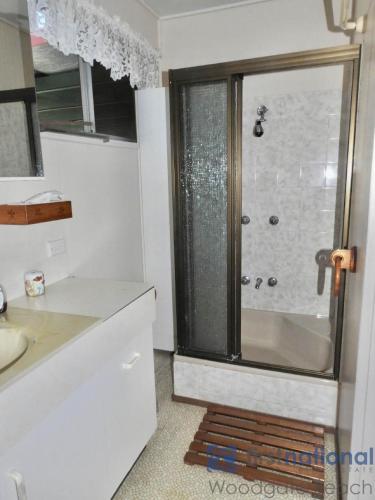 a bathroom with a shower with a glass door at 25 Walkers Point Esplanade in Woodgate