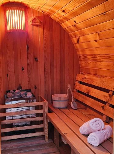 a wooden sauna with towels on a wooden bench at Kuća u prirodi, wellness oaza Kalimera in Draganići