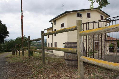a wooden fence in front of a building at Agriturismo Casale 1921 in Torre le Nocelle