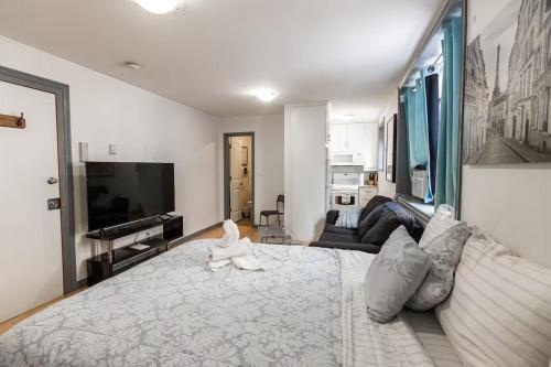 a bedroom with a large bed with a stuffed animal on it at Suitestay Apartments Hotel in Ottawa
