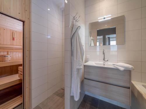 a bathroom with a sink and a mirror at SeaLuxe Suite 27D in Colijnsplaat