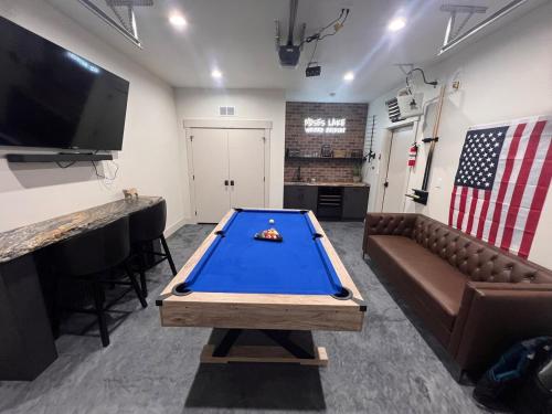 a pool table in a room with a couch and a television at Moses Lake Vineyard Retreat-Waterfront Escapism in Moses Lake