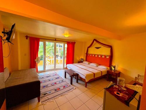 a bedroom with a bed and a large window at BEACH HOTEL INES en Zicatela in Brisas de Zicatela