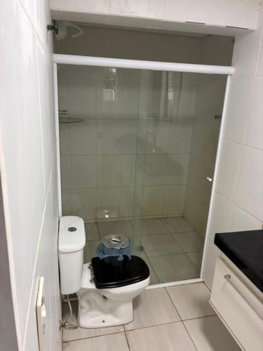 a bathroom with a toilet and a glass shower at pousada ranchinho sorocaba in Sorocaba