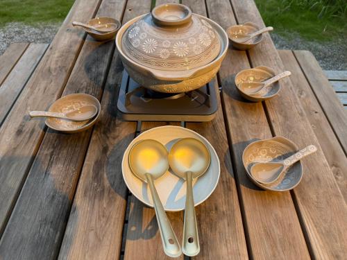a wooden table with spoons and a pot on it at WATERSIDE Base 鹿嶋 北浦 in Kashima