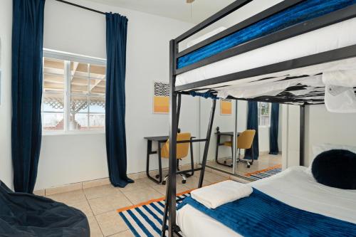 a bedroom with a bunk bed and a desk at Near Safari & Beach - Backyard Games - AC - Pet OK in Escondido