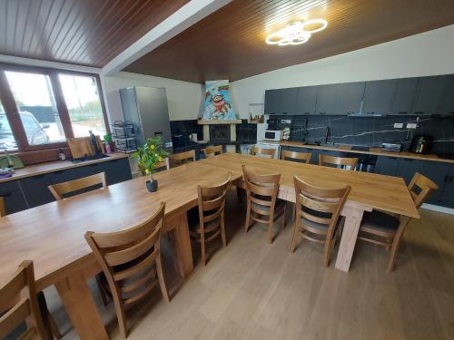a large kitchen with a large wooden table and chairs at Къща за гости Бела in Targovishte