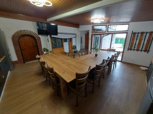 a large dining room with a large wooden table and chairs at Къща за гости Бела in Targovishte