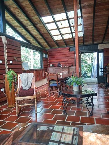 a living room with chairs and a table on a brick floor at Paz y Tranquilidad in Marsella