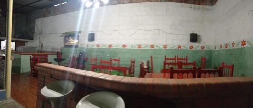 a room with a table and chairs in a building at Hotel casa reina in Ibagué