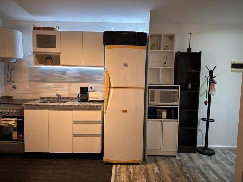 a kitchen with a refrigerator in the middle of it at Stylish Modern apartment with automatic parking in Buenos Aires