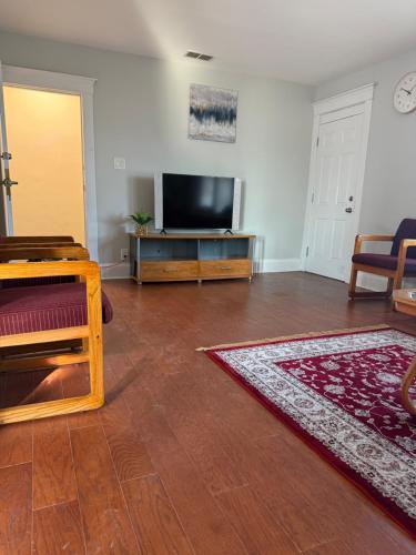a living room with a flat screen tv on a table at Comfortable 3-BR Home Minutes From UB South & Shop in Buffalo