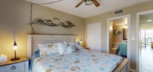 a bedroom with a bed and a ceiling fan at Beachfront Space Coast Gem with Heated Pool, Sleeps 4 in Cape Canaveral