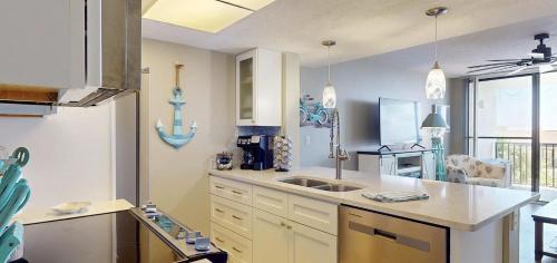 a kitchen with a sink and a counter top at Beachfront Space Coast Gem with Heated Pool, Sleeps 4 in Cape Canaveral