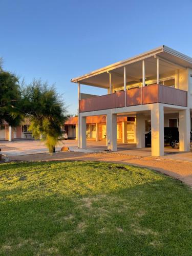 a large house with a lawn in front of it at Archy's on the Lake in Burrill Lake