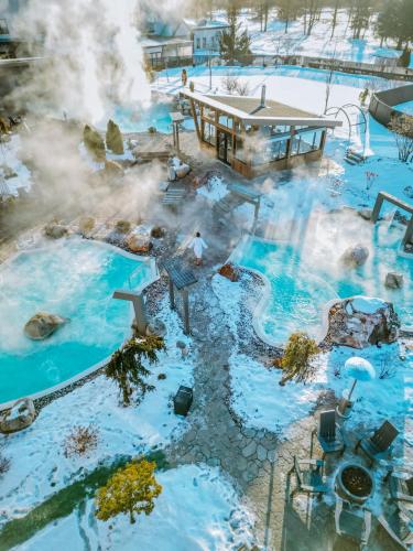 an overhead view of a geothermal spa with snow at Chateau Cartier Hotel & Resort, an Ascend Collection Resort in Gatineau