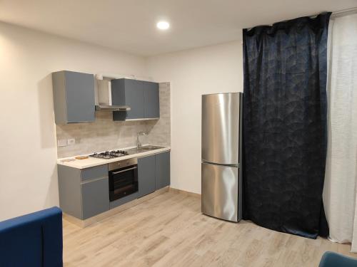 a kitchen with a stainless steel refrigerator in it at Casa Gisella Surf House in Ladispoli