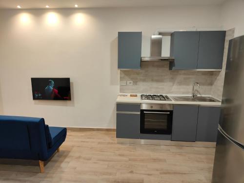 a kitchen with a sink and a stove top oven at Casa Gisella Surf House in Ladispoli