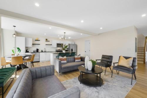 a living room with a couch and chairs and a kitchen at Spacious 5BR Home KING Bed Wi-Fi Parking in Bloomfield
