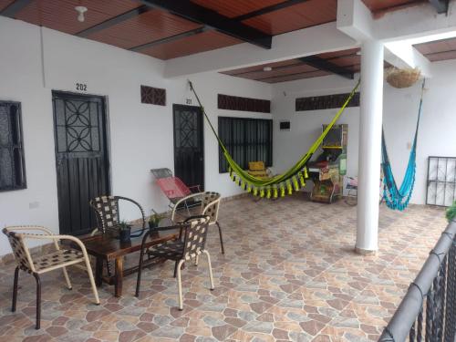 a living room with a hammock and a table and chairs at Hospedaje Lulú - Licores 24 in Girardot