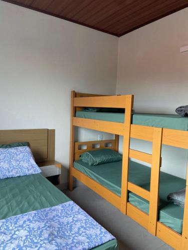 Кровать или кровати в номере Recanto dos Pássaros