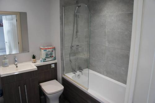 une salle de bains avec douche, toilettes et lavabo dans l'établissement Melbourne House Gem Stylish 2-bed In City Centre, à Accrington