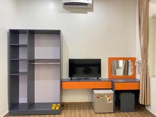 a lego office with a desk and a tv at Holiday Hotel 2 in An Khê