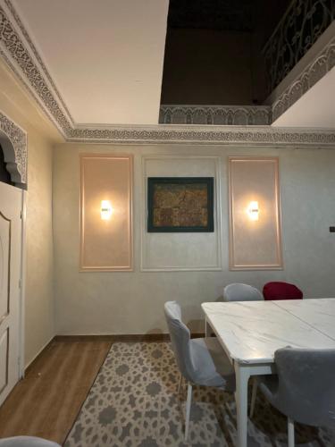 a dining room with a white table and chairs at Riad 052 in Marrakech