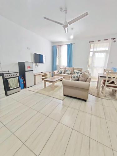 a living room with a couch and a table at Tee,s Homestay in Mtwapa