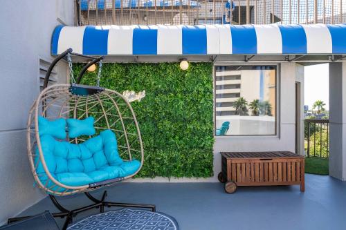 a porch with a blue chair on a balcony at Studio with Private Terrace and Volcano Bay View Near Epic Universe in Orlando