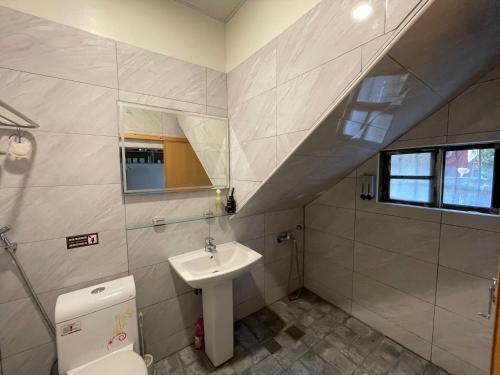 a bathroom with a sink and a toilet at Lao Fan Home in An-shuo