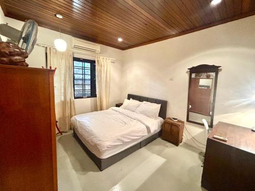 a bedroom with a bed and a wooden ceiling at Chic Designer Room in Shared Bungalow SS1 Near LRT Petaling Jaya in Sungai Way