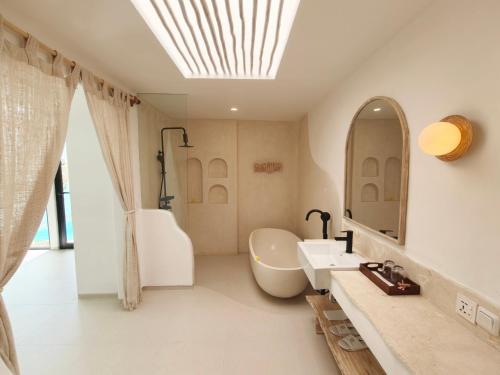 a bathroom with a sink and a mirror at Villa Aurora - Stylish 2 Bedroom Villa with Mediterranean Style in Badung