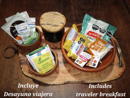 two bowls filled with food on a wooden table at Sumaj Rústica in Maimará