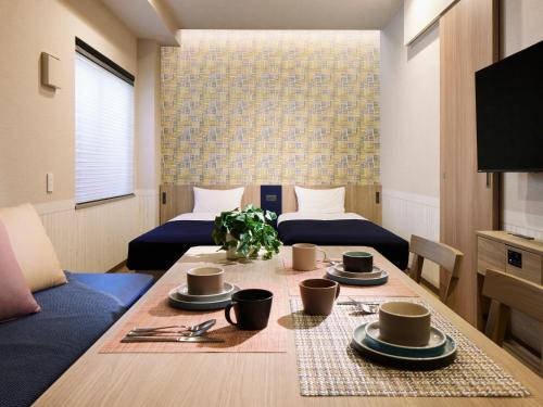 a room with a table with cups and plates on it at Minn Kasai in Tokyo