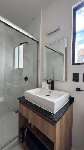 a bathroom with a white sink and a shower at House Alto 58 Xochitepec Morelos in Xochitepec