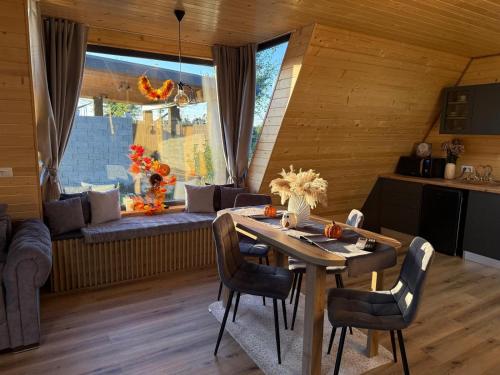 a kitchen and dining room with a table and chairs at A Frame Bâlea Chalet in Cîrţişoara