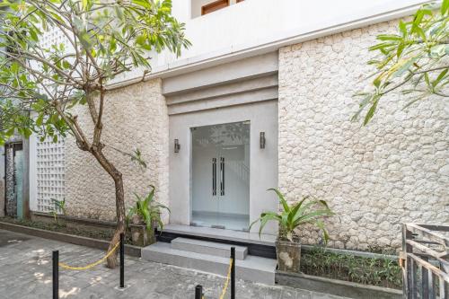 a front door of a building with plants at Srikrisna in Seminyak