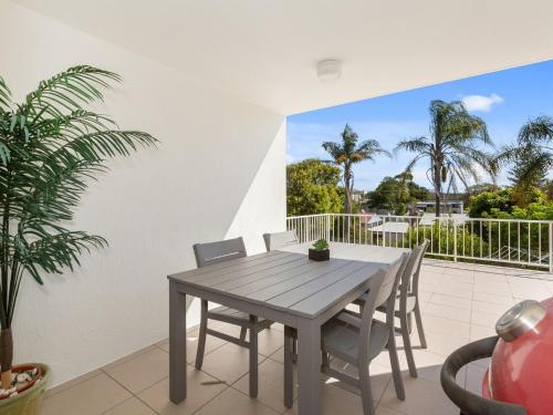 a dining room table and chairs on a patio at Ocean Outlook 2 on Marine Parade in Kingscliff