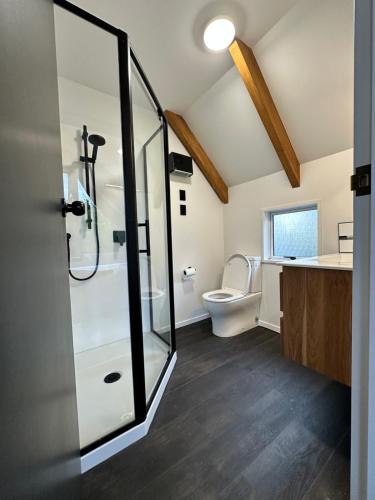 a bathroom with a shower and a toilet at Kaikōura Mountain View Lodge in Kaikoura