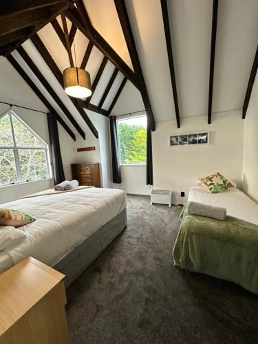 a bedroom with two beds and a large window at Kaikōura Mountain View Lodge in Kaikoura