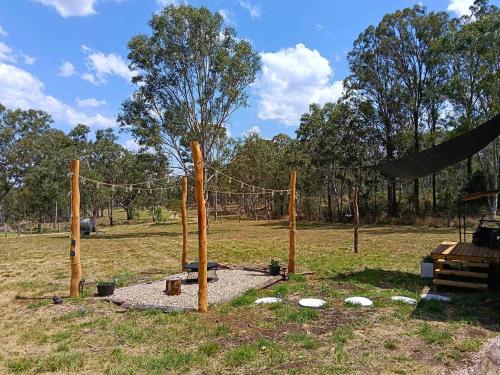 a playground with a net in a field at Kalmya Farm Retreat by Tiny Away in Nanango