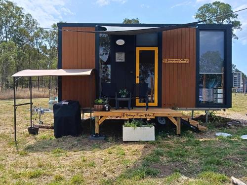 a tiny house sitting on a table in a field at Kalmya Farm Retreat by Tiny Away in Nanango