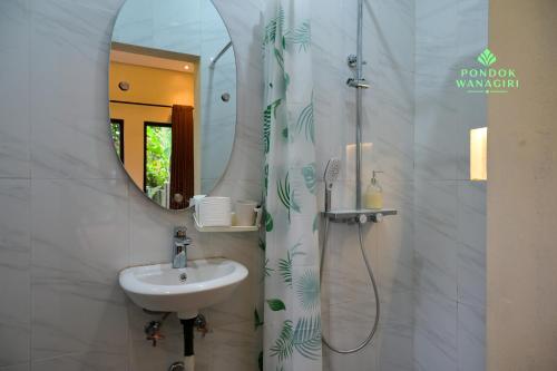 a bathroom with a sink and a mirror at Pondok Wanagiri in Gitgit