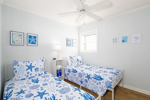 a bedroom with a bed and a chair at Coast is Clear- Oceanfront Escape at Topsail Dunes in North Topsail Beach