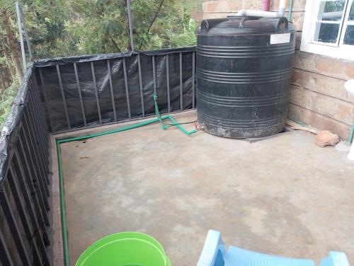a large black barrel sitting next to a fence at Sacred Heart Apartments BNB & Hostels Meru Town in Meru