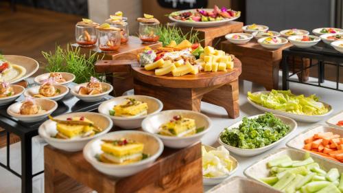 a buffet with many plates of food on a table at Marriott Executive Apartments Bengaluru UB City in Bengaluru
