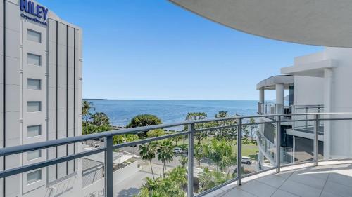 a view of the ocean from the balcony of a hotel at Ocean View 3-Bedroom Apartment on the Esplanade in Cairns