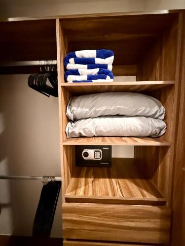 a closet with a wooden organizer with towels at Modern Luxury Residency at Altea-Sunset Pool View in Puerto Vallarta